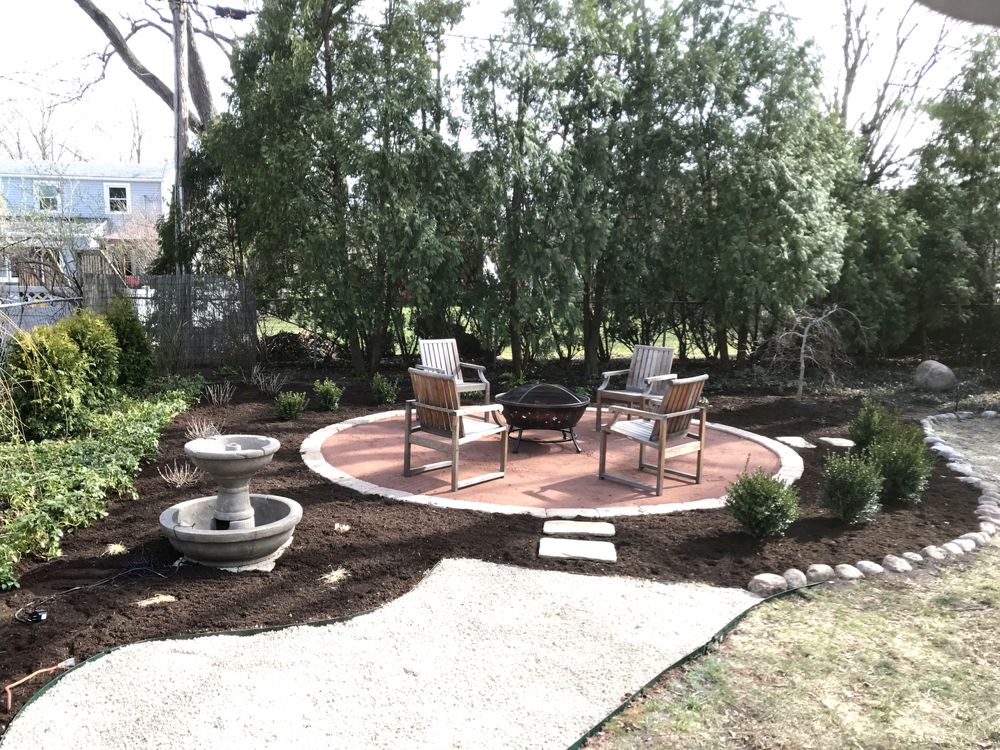 Custom paver brick walkway winding through front yard landscaping