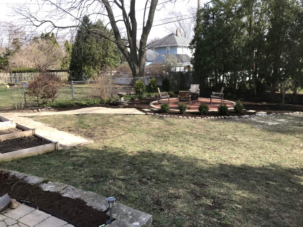 Finished brick paver patio with fire pit and retaining seat walls